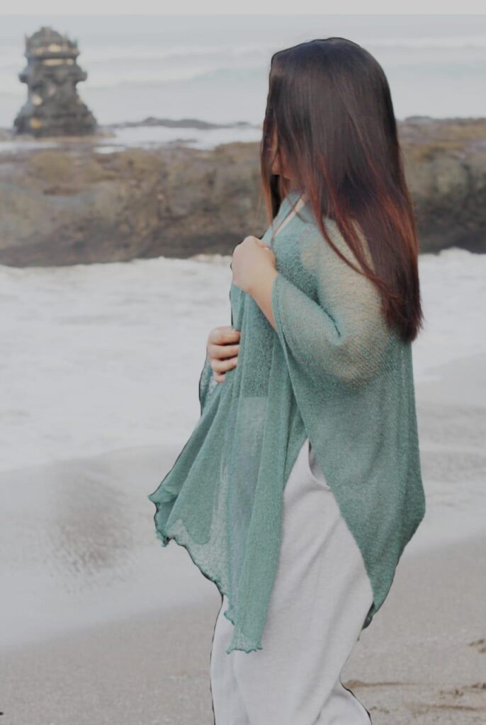 Close-up of fine knitted fabric texture in sheer shrug