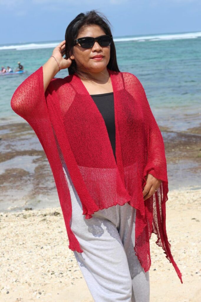 Sheer knitted shrug in cream color displayed on a mannequin